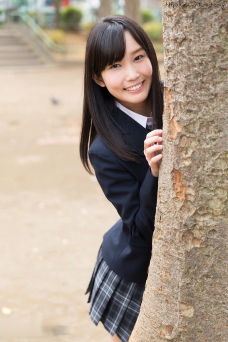 Sweet Japanese schoolgirl pulls down panties showing bare ass in the library