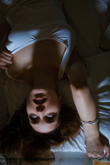 Erotic teen with blue eyes and big puffy nipples posing naked in the shadows