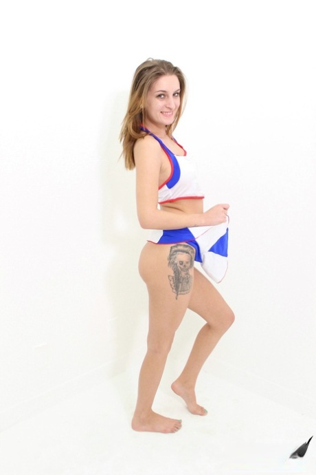 Cheerleader Maci Winslett takes off her uniform to stand totally naked