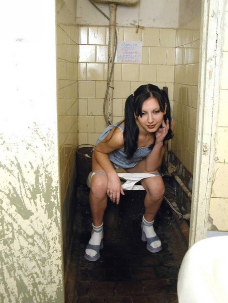 Teen girl in pigtails squats for a pee on the filthiest toilet know to mankind