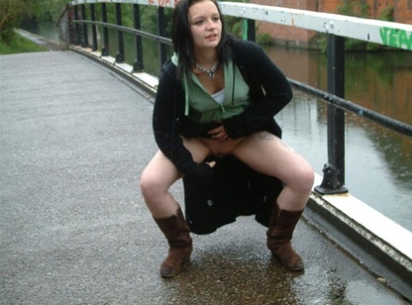 British chick with a shaved pussy pisses on a bank a railed walkway