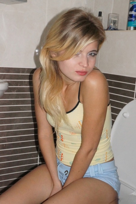 Young cutie Zoey Ryder bares her tiny tits and blows bubbles on the toilet