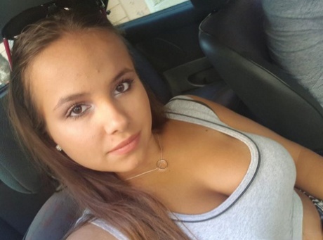 Young looking Latina girl Olivia hides her huge tits while taking selfies