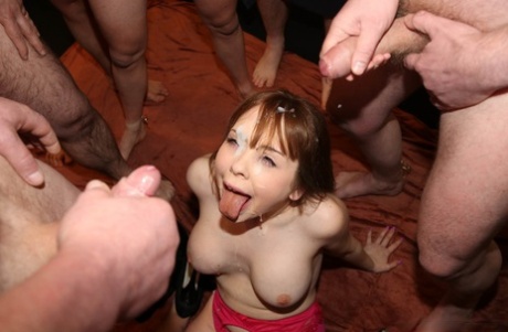 Natural redhead Cherry English gets on her knees for a bukkake session