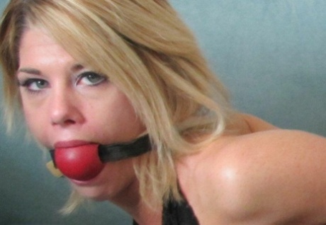 Blonde chick is silenced with gags while hogtied in denim cutoffs and heels