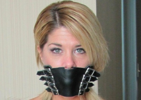 Blonde chick is silenced with gags while hogtied in denim cutoffs and heels