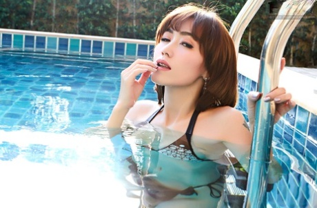 Asian beauty Yuri fondles her big natural tits while in a swimming pool