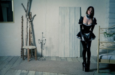 Korean model poses for a solo shoot in a naughty rubber maid outfit