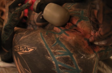 Heavily tattooed girl fists her pussy after masturbating with a sex toy