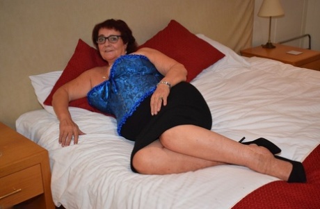 Overweight granny Phillipas Ladies undoes her bustier during solo action
