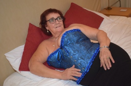 Overweight granny Phillipas Ladies undoes her bustier during solo action