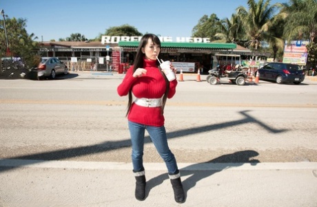 Asian girl with long hair Hitomi fills out her red sweater in non nude action