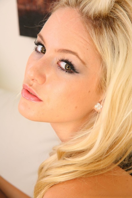 Blonde in sexy lingerie Faye covers her tiny tits while stripping