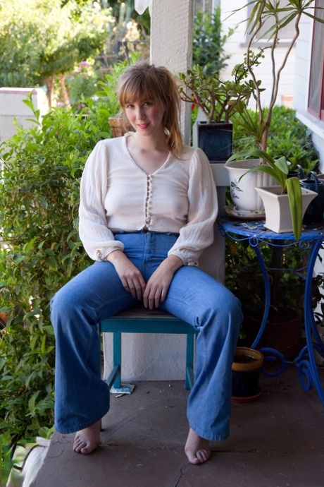 Amateur model Tilly Hannon poses non nude on porch before removing blue jeans