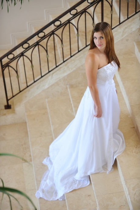Busty glamorous amateur Danielle models wedding gown indoors & by the pool