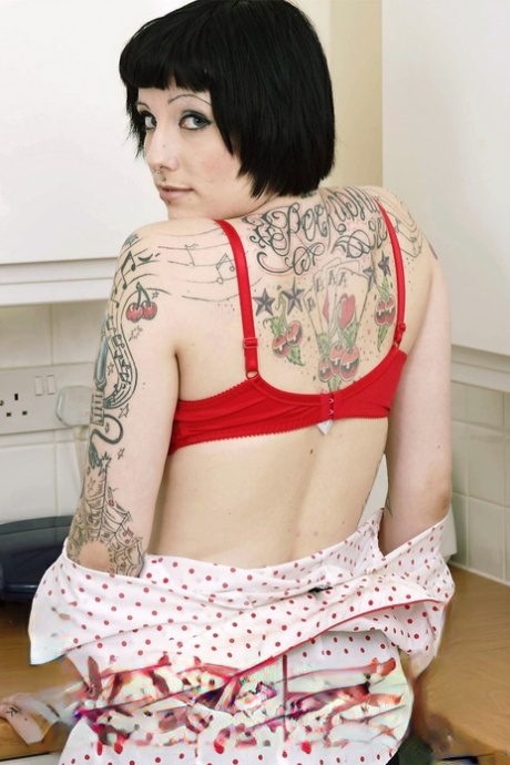 Tall inked goth peels in the kitchen to flaunt her tats & pussy on the counter