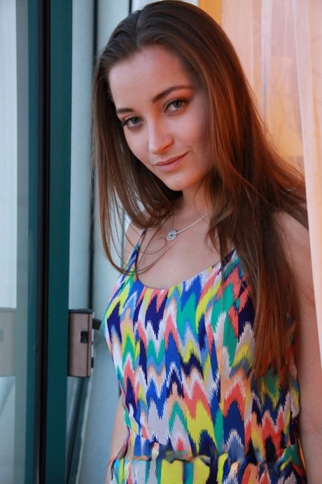 Dani Daniels takes off her colorful dress to show big ass and natural tits