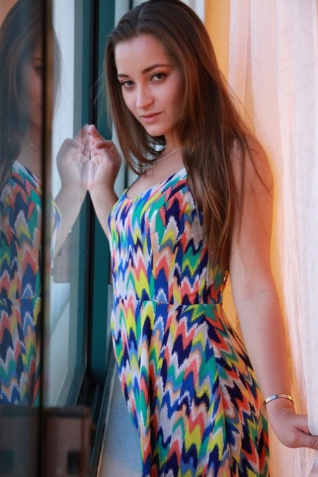 Dani Daniels takes off her colorful dress to show big ass and natural tits