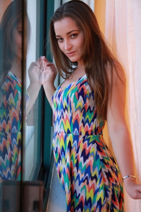 Dani Daniels takes off her colorful dress to show big ass and natural tits
