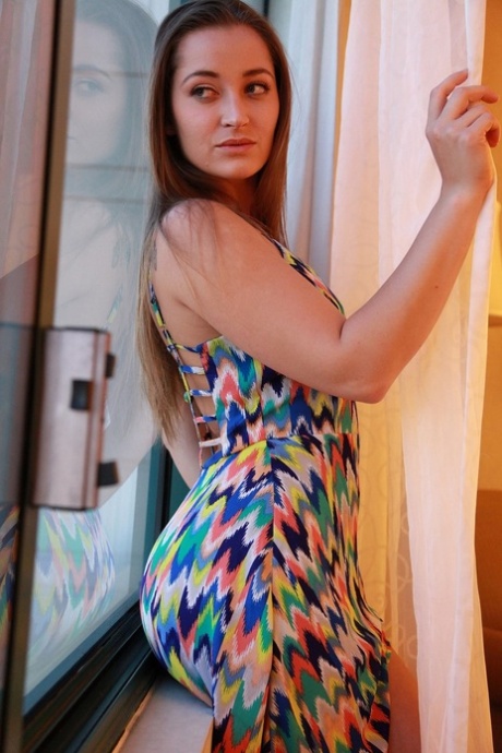 Dani Daniels takes off her colorful dress to show big ass and natural tits