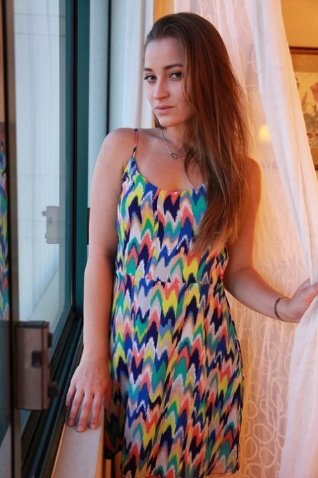 Dani Daniels takes off her colorful dress to show big ass and natural tits