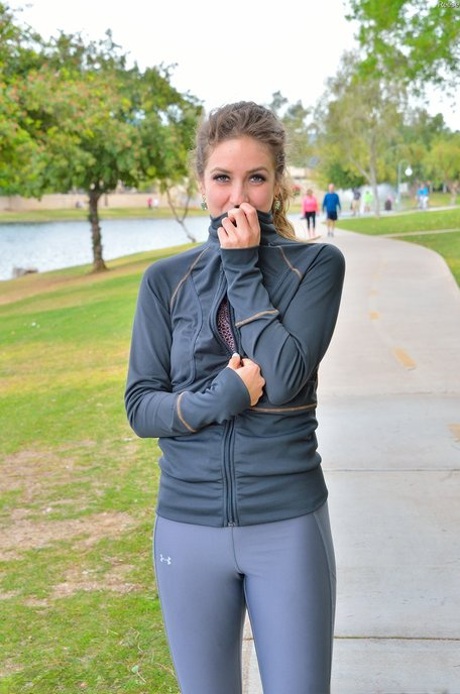 Cute jogger Reese undresses and shows her tiny tits and flexibility outdoors