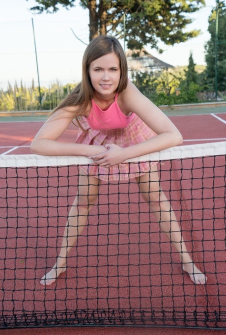 Pretty tennis player Sanny strips naked & shows off her shaved pussy