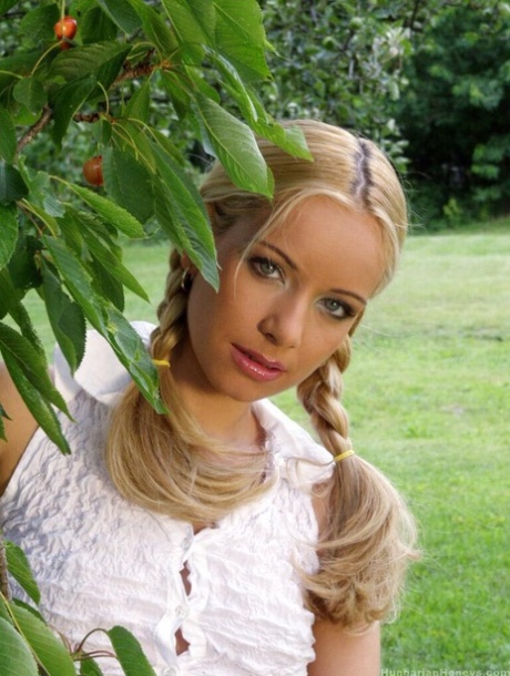 Young blonde Jennifer Reed climbs a tree & toys her trimmed pussy with a dildo