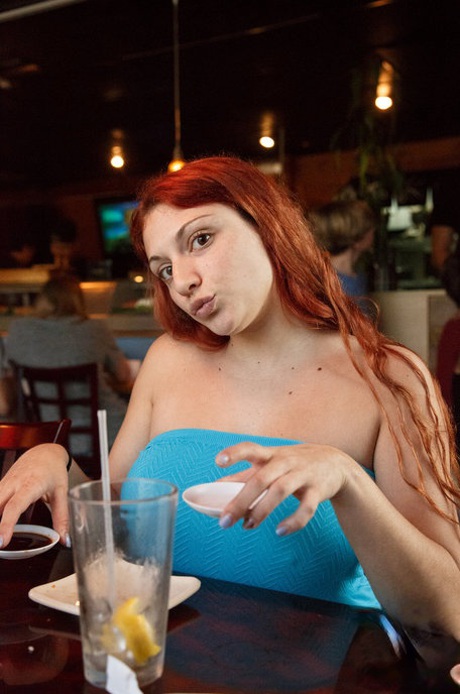 Curvaceous redhead Gina Rosini flashes her big tits, round ass and hairy twat