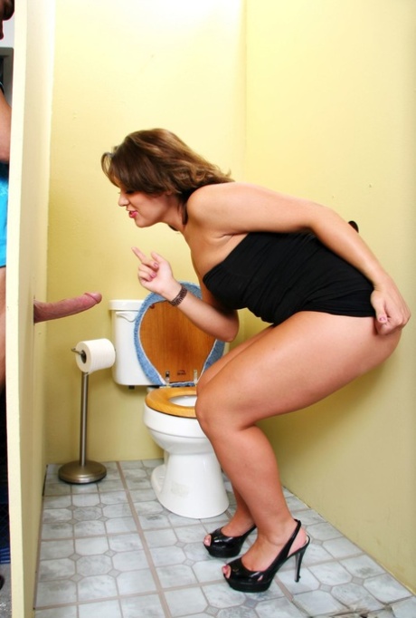 Curvy MILF in a little black dress sucks and rides a big dick at the gloryhole