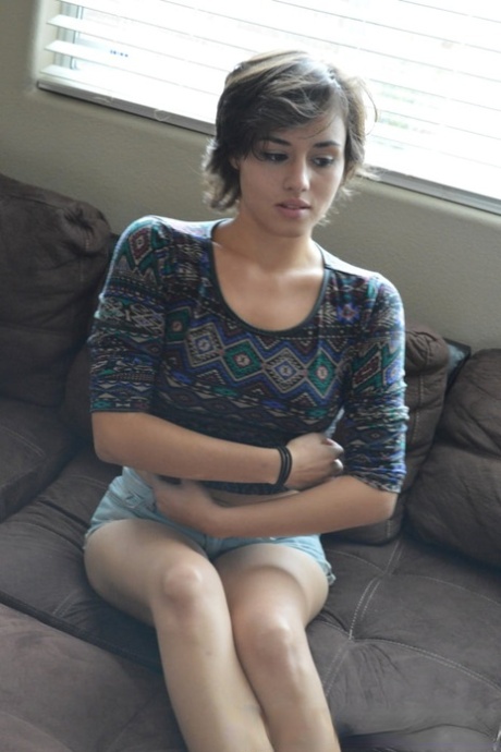 Amateur babe strips fully naked  masturbates with a dildo on the couch