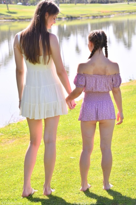 Horny tall babe Mira & her petite friend Olivia strip & pose naked outdoors