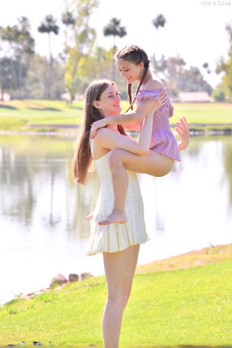 Horny tall babe Mira & her petite friend Olivia strip & pose naked outdoors