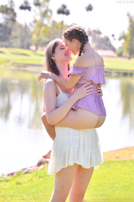 Horny tall babe Mira & her petite friend Olivia strip & pose naked outdoors