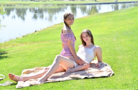 Horny tall babe Mira & her petite friend Olivia strip & pose naked outdoors