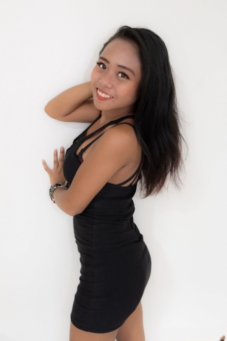 Sexy Asian hooker Joylyn strips her dress & lingerie & poses naked