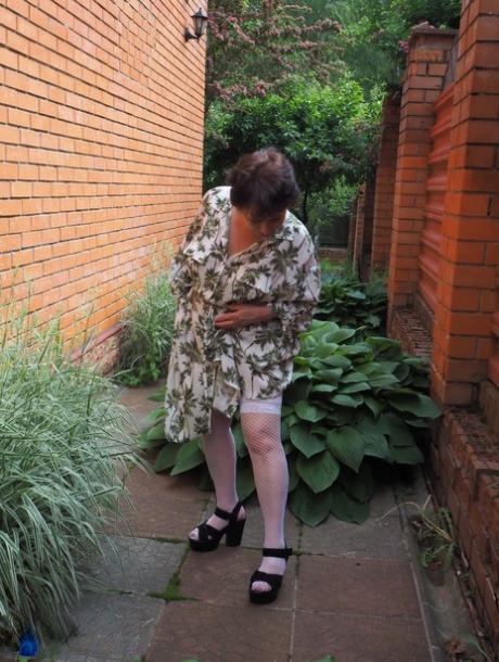 Kinky GILF Nata reveals her big booty and big tits and fingers herself